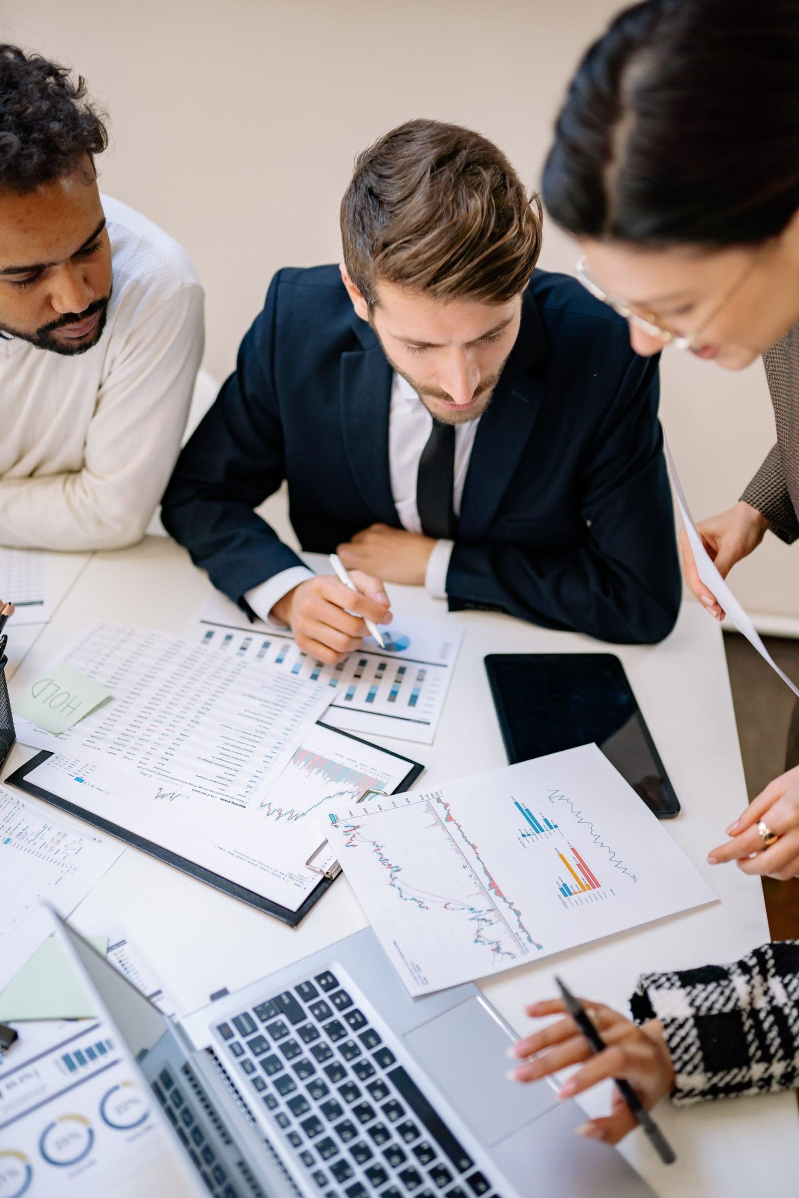A brand team reviewing a creator's performance charts and analytics around a table